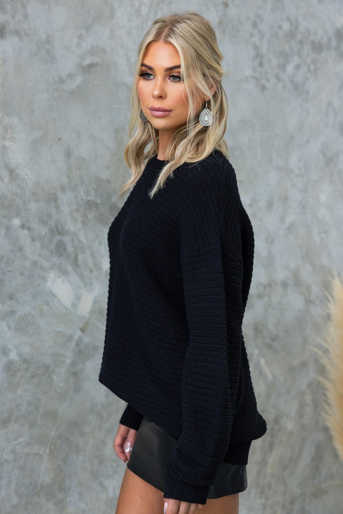 Model wearing a black Rhode Jumper with a round neckline, featuring a relaxed fit and knit texture.