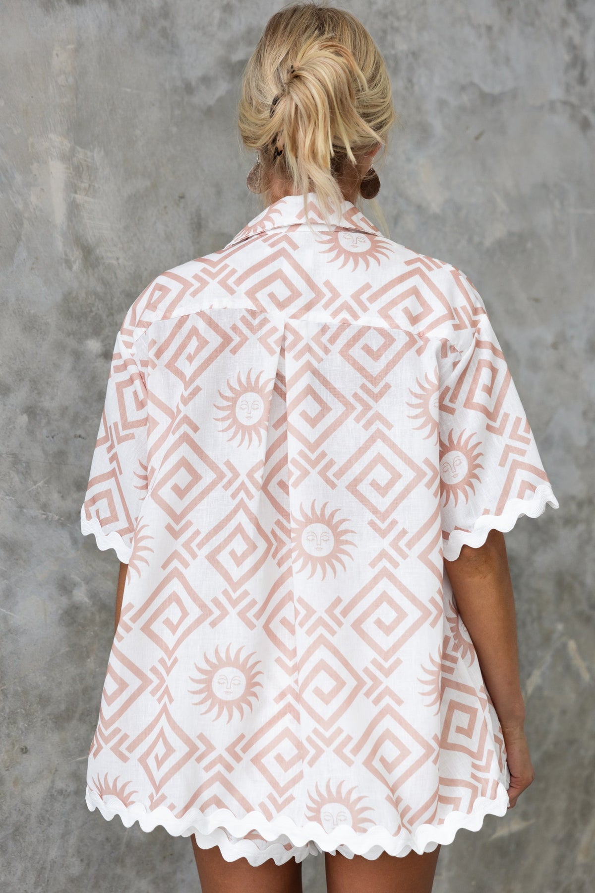 Back view of the Take It Easy shirt featuring a pink geometric and sun pattern on a relaxed fit, perfect for casual wear.