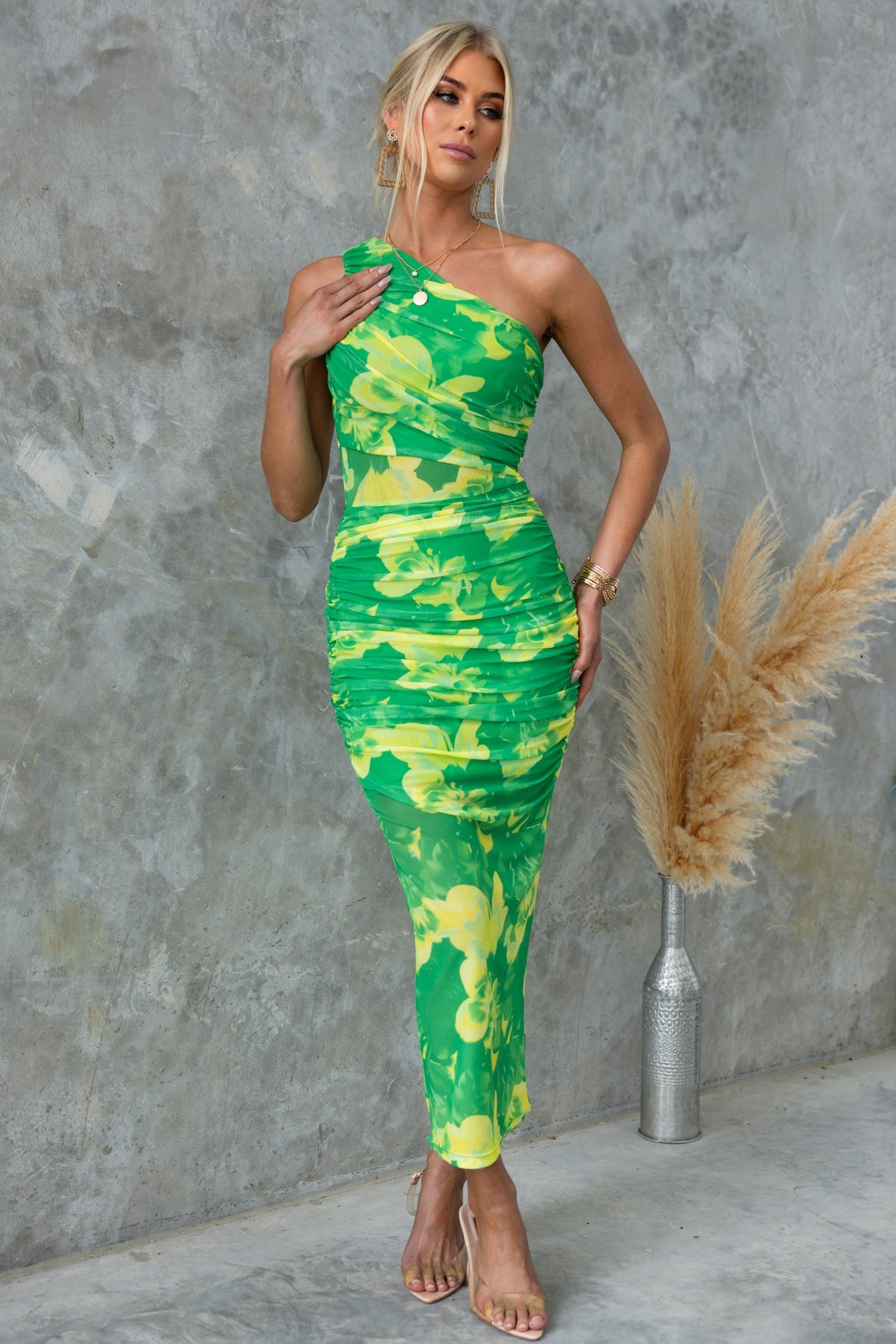 Sundara Maxi Dress in vibrant green and yellow floral print, featuring a one-shoulder neckline and fitted silhouette.