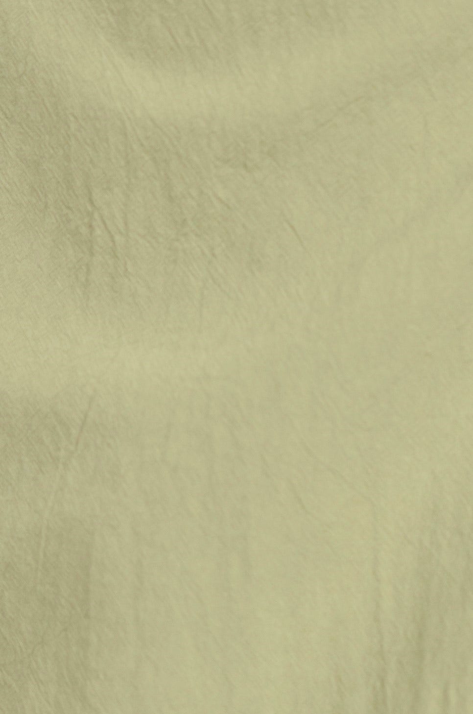 Close-up of soft, light green crepe fabric used in a stylish maxi dress.