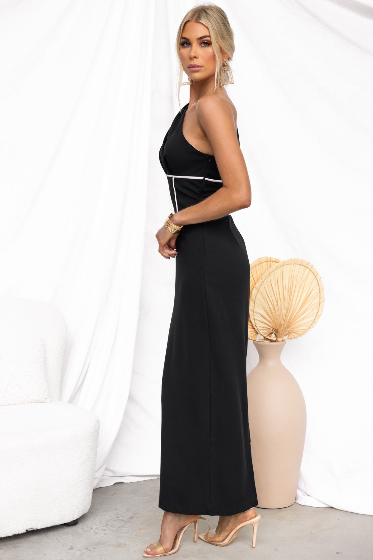 Elegant one-shoulder black maxi dress with stylish side zip and back split, showcasing a sleek silhouette.
