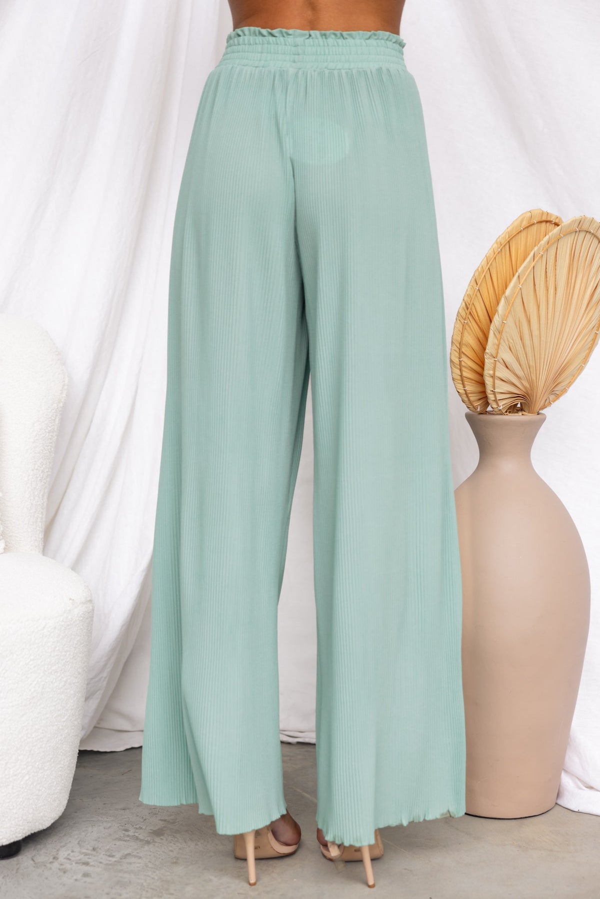 Back view of Barbara Pants in mint green, featuring an elastic waistband and wide-leg design.