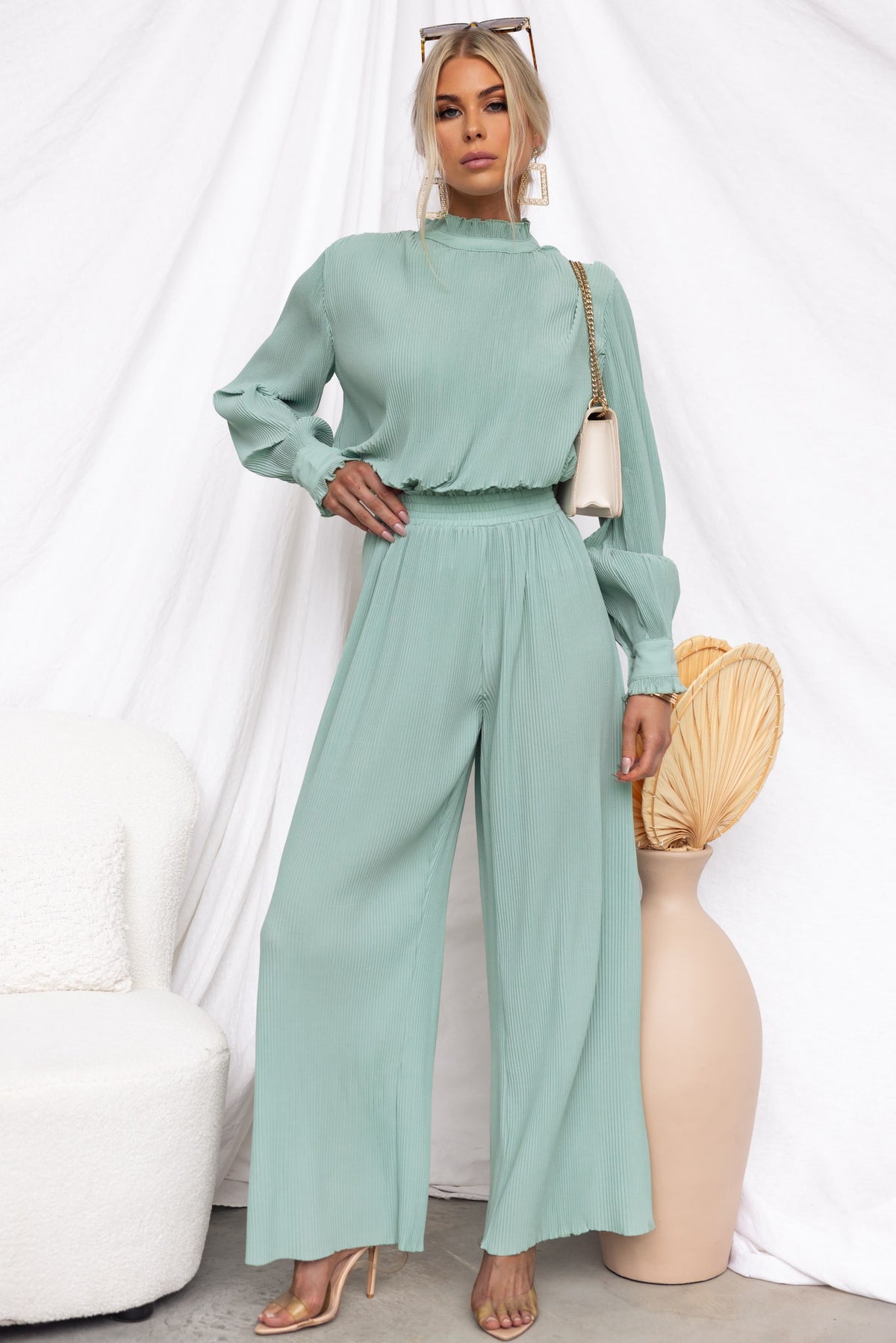 Model wearing elegant mint green Barbara Pants with a matching top, featuring an elastic waistband and flowy design.