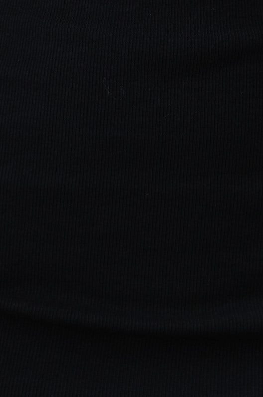 Close-up of ribbed black fabric texture for Carry Me Top, featuring stretch material and a rich color.