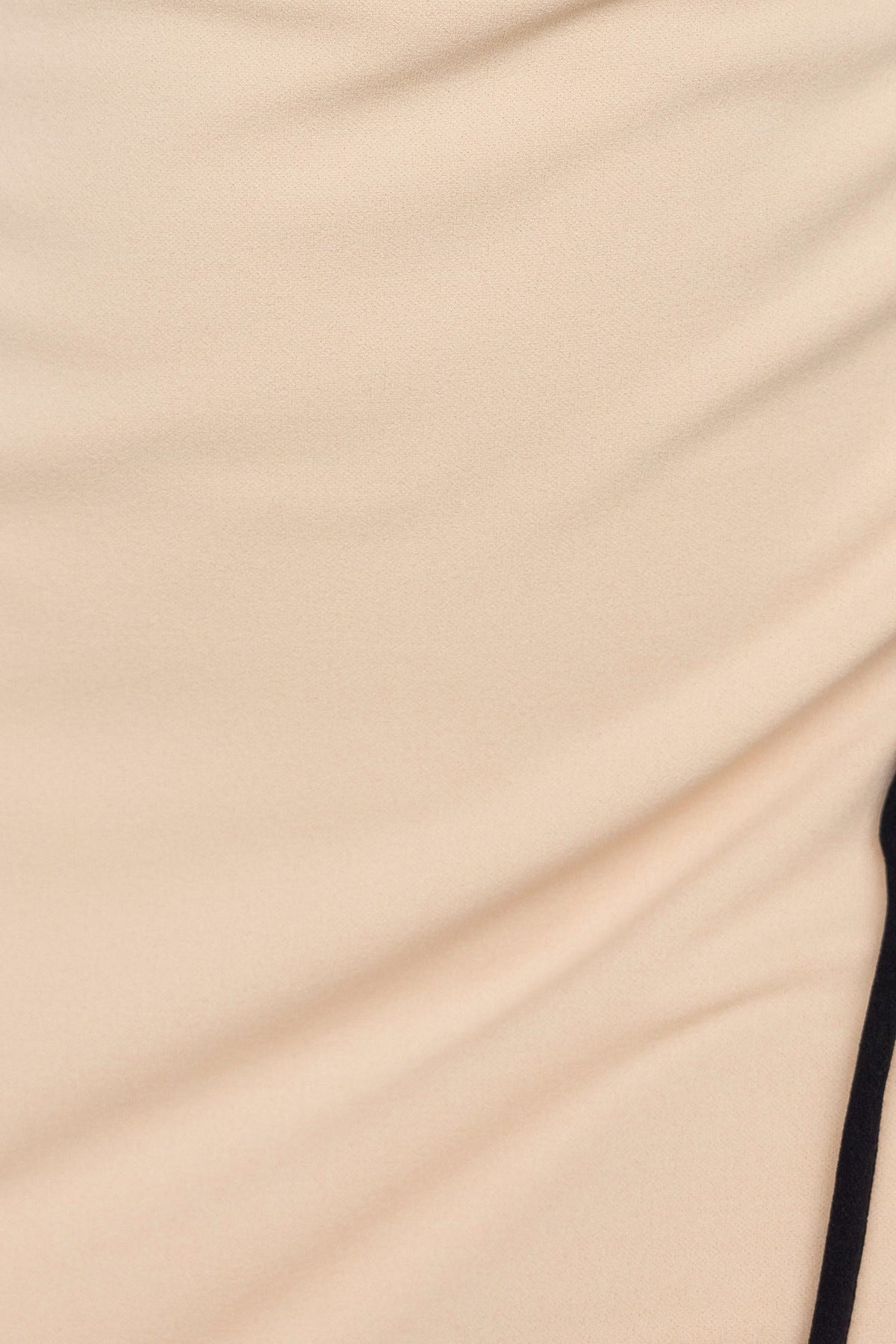 Close-up of crepe fabric in beige with a black trim, showcasing the soft texture and stretch of the Nabila Maxi Dress.