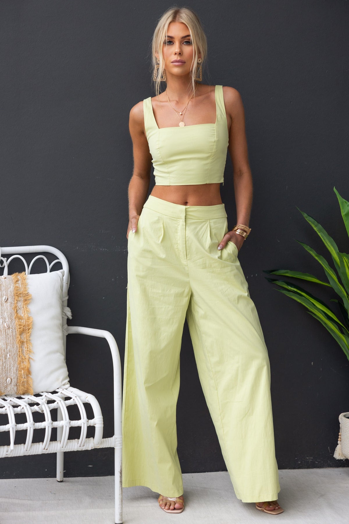 Model wearing Janae Pants in light yellow, styled with a matching crop top, showcasing high-waist fit and pockets.