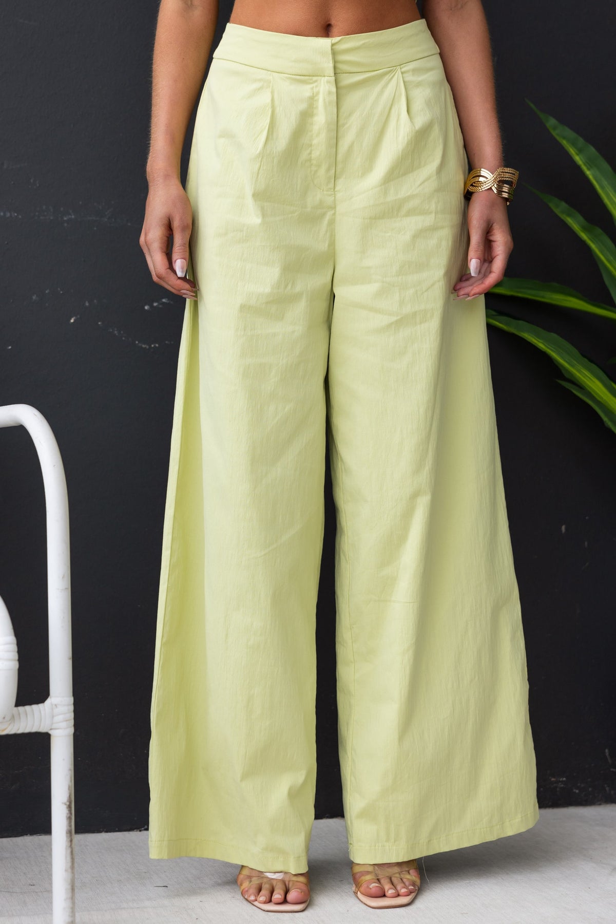 Janae Pants in light green, mid-high waist fit with pockets, cotton-like feel, model wearing size 6/XS.
