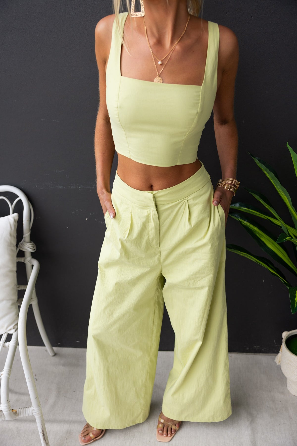 Janae Top featuring a square neckline and adjustable straps, paired with wide-leg pants in a soft pastel green.