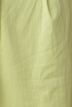 Close-up of soft, textured light green fabric showcasing a smooth and gentle appearance.