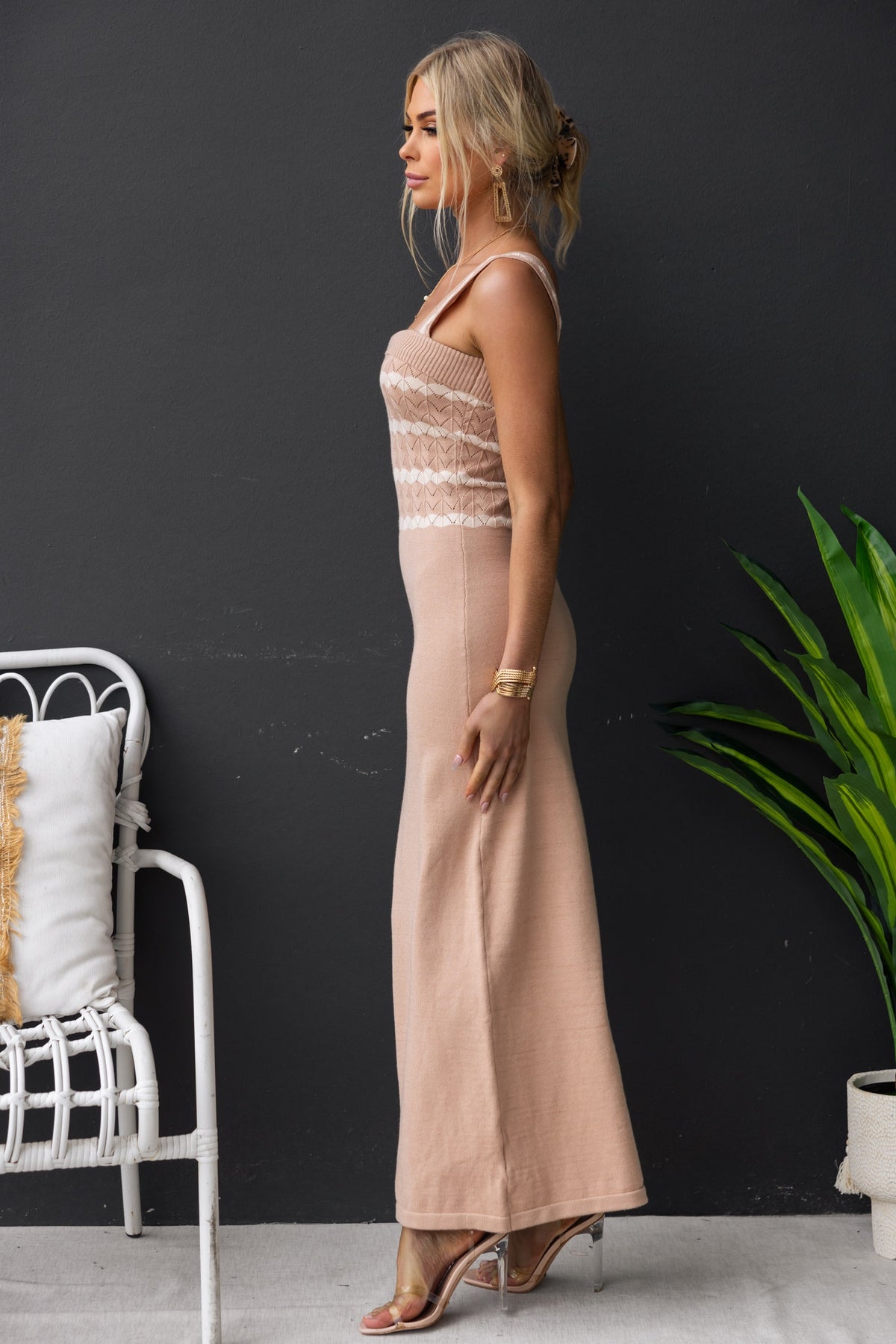 Profile view of a woman wearing the Tarnya Maxi Dress, a beige knit dress with lace overlay details.