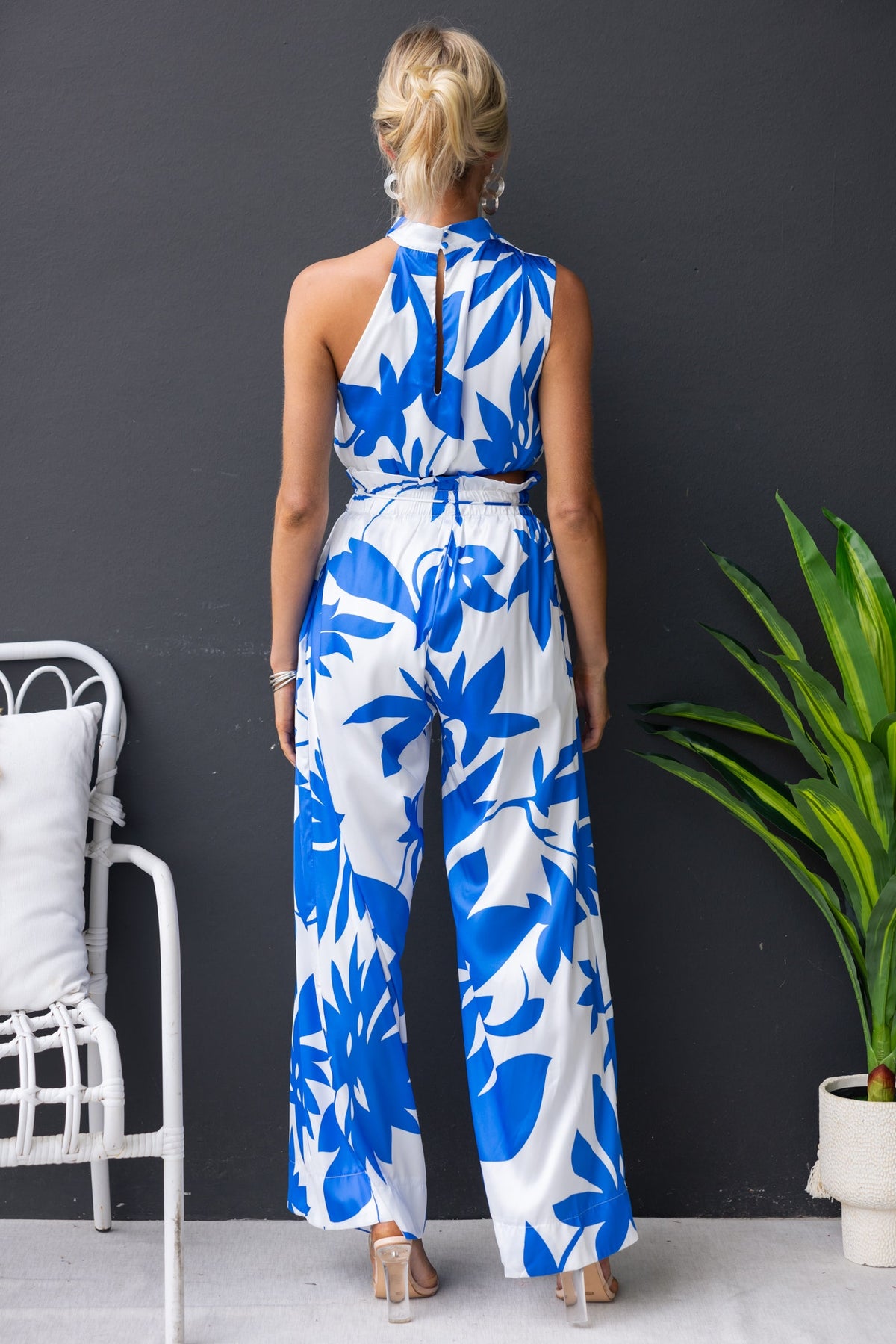 Model wearing the Dreamie Set featuring a blue floral design, mid-high waist pants, and a stylish sleeveless top.