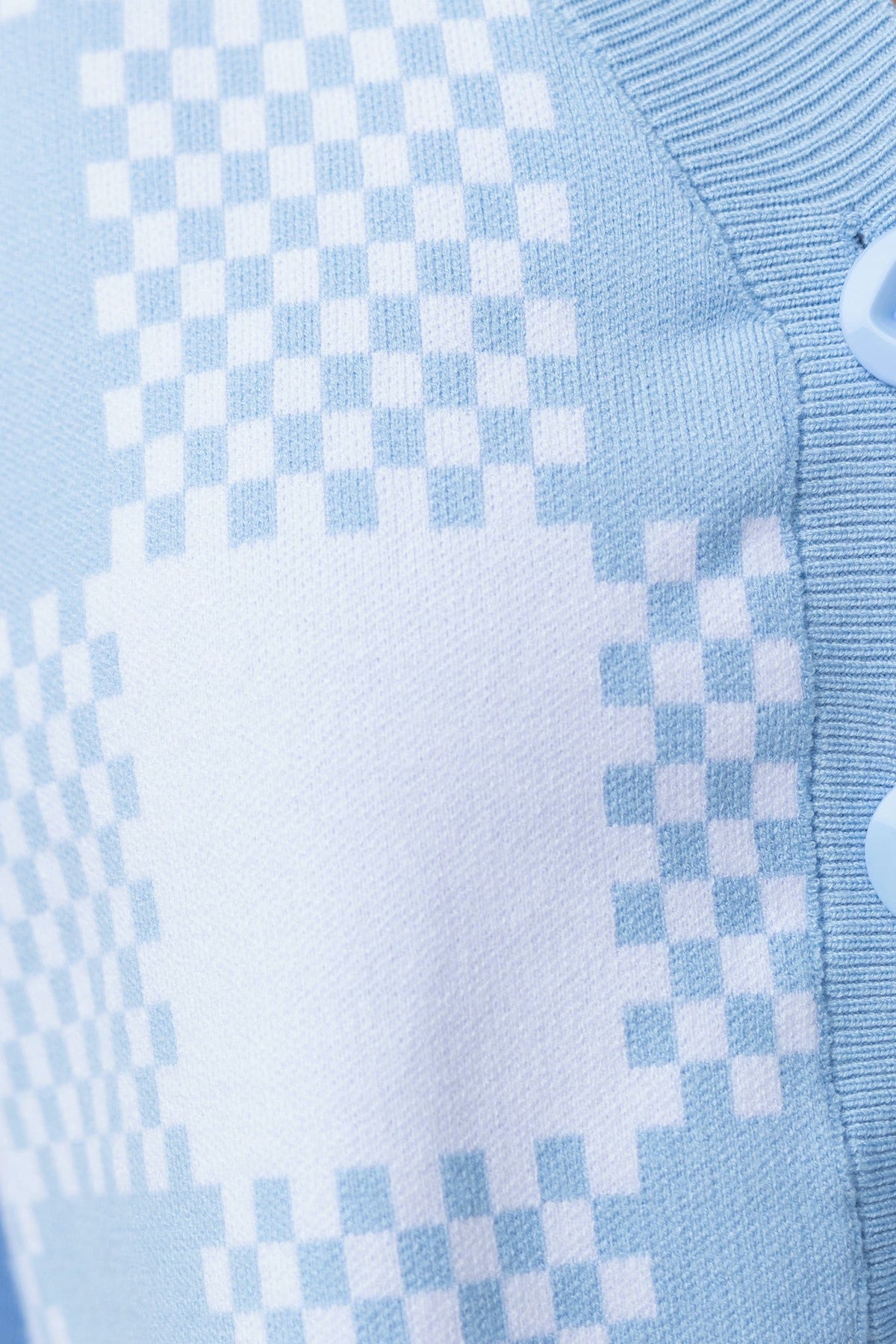 Close-up of Roni Cardigan in light blue with a checkered pattern and button detail.