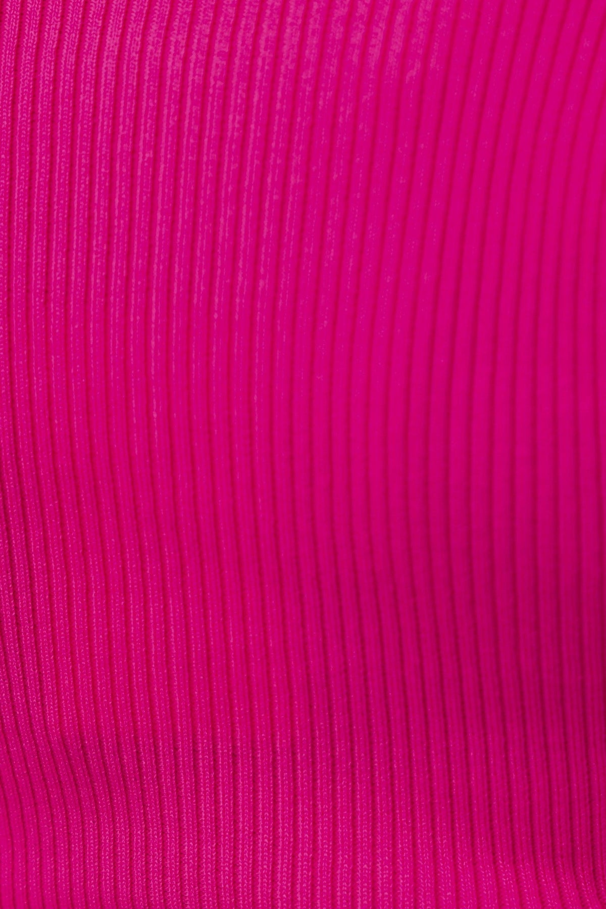 Close-up of ribbed pink fabric, showcasing the stretchy material of the Regina Top.