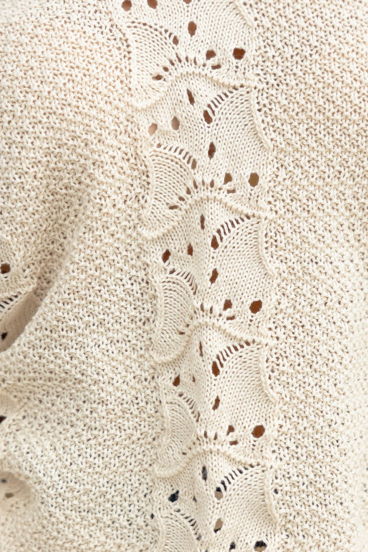 Close-up of Cadie Knit top showcasing a semi-open weave design in a soft beige color.