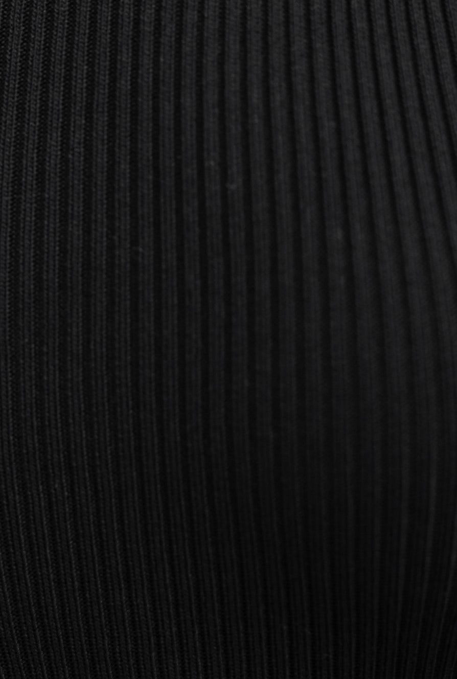 Close-up of black ribbed knit material, showcasing texture and stretch ideal for a fitted dress.
