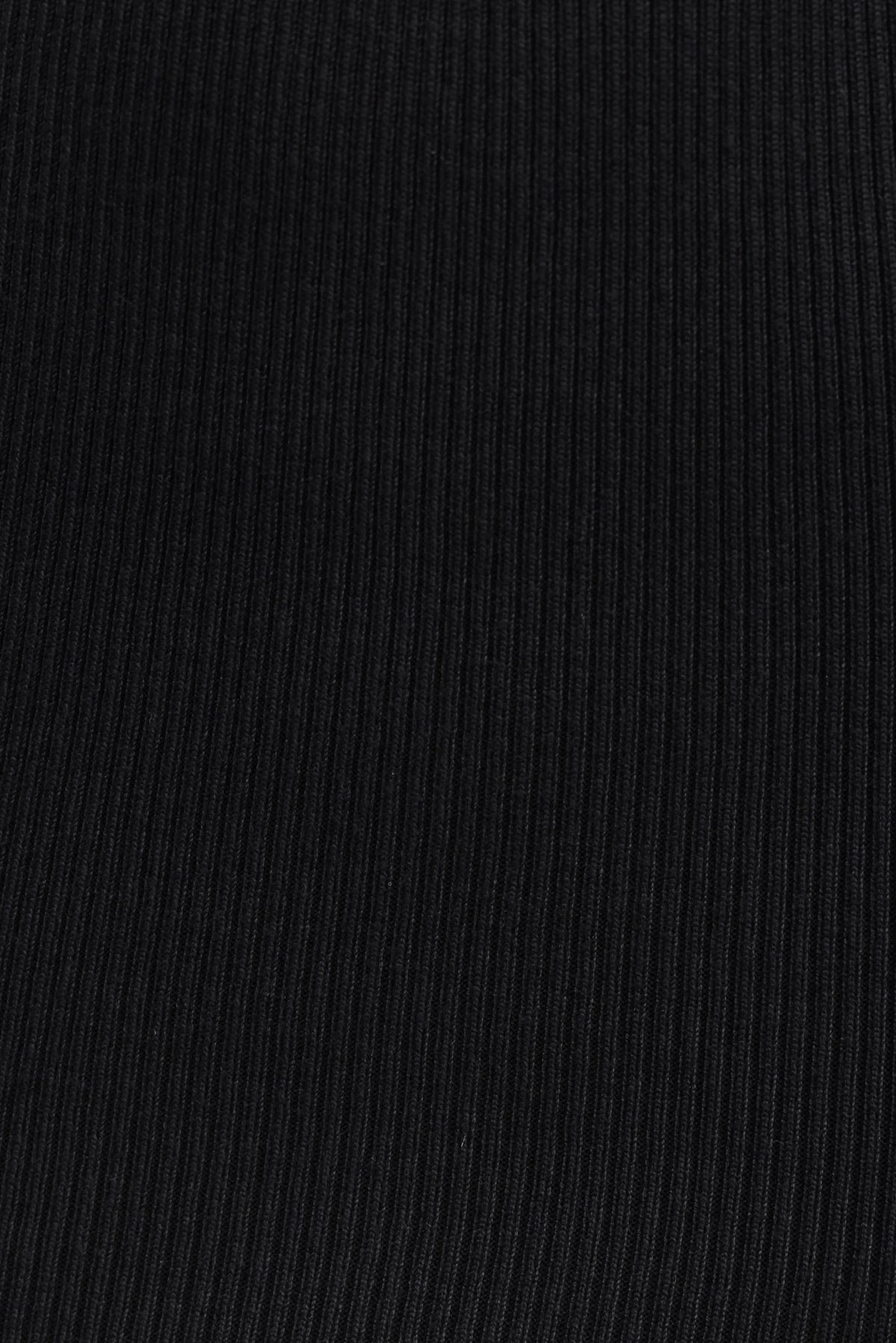 Close-up of black ribbed fabric showcasing texture, perfect for stylish maxi skirts.