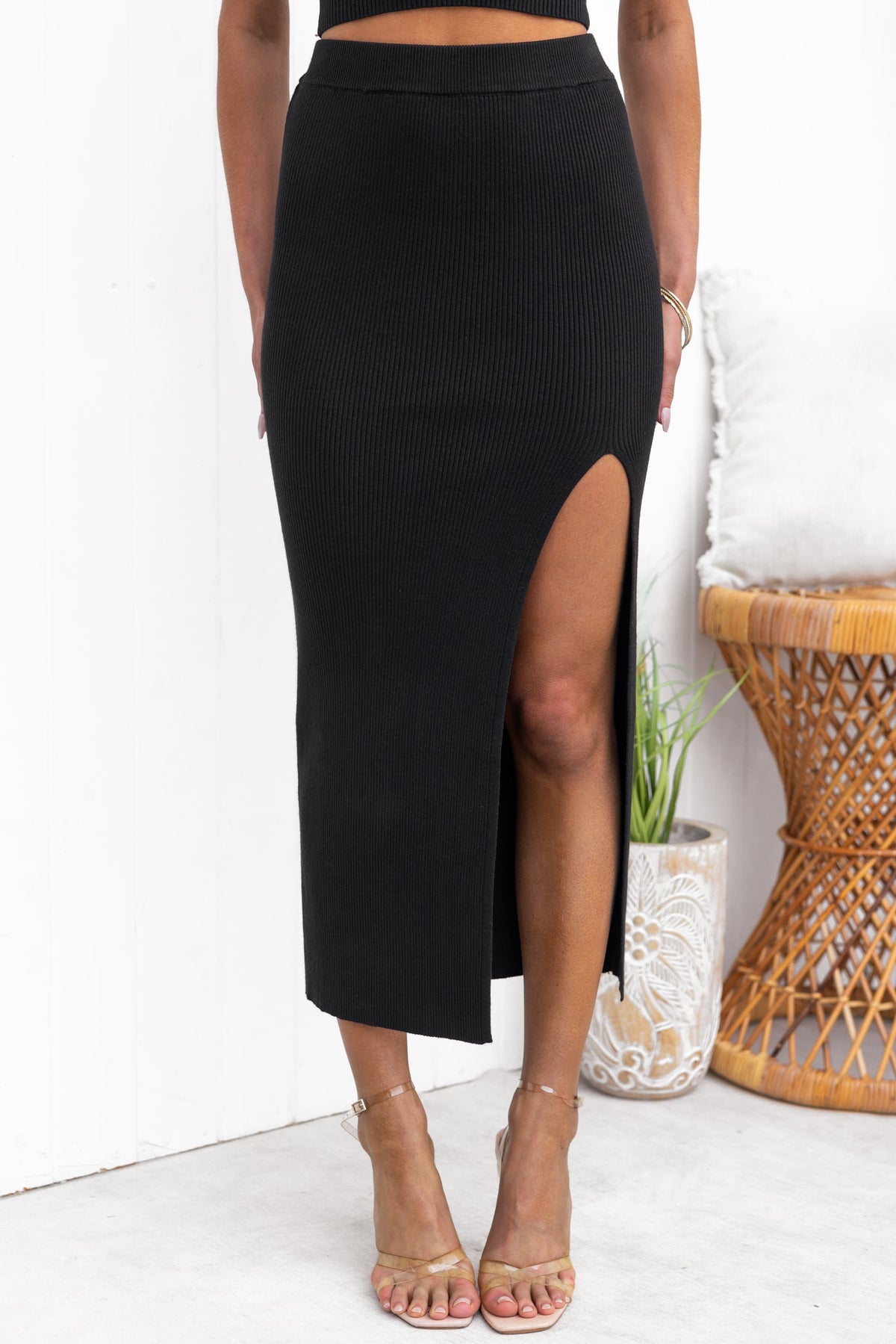 Black Estha Maxi Skirt with front split, mid-high waist, made from stretchy ribbed material.