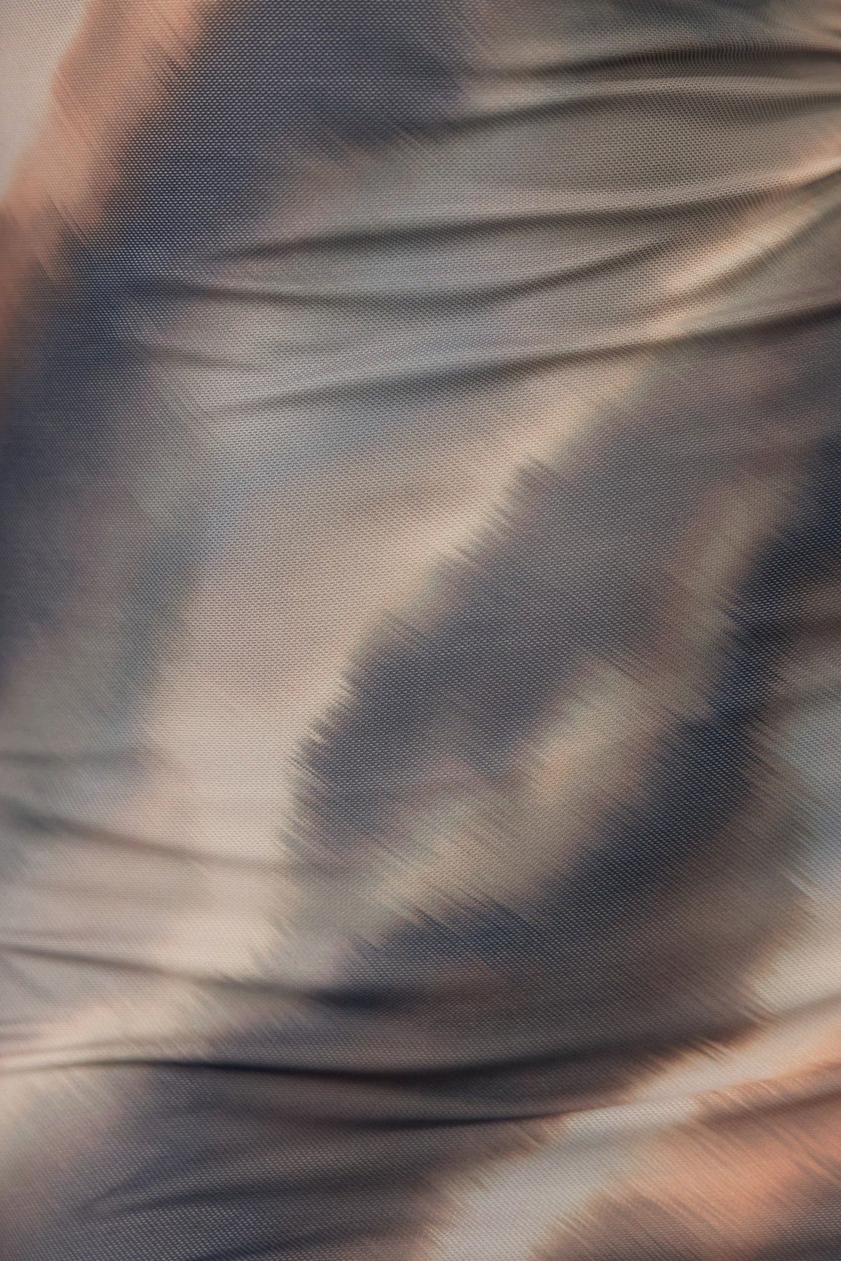 Close-up view of fabric texture with abstract shades of brown and beige, showcasing the Byrne Dress's unique pattern.