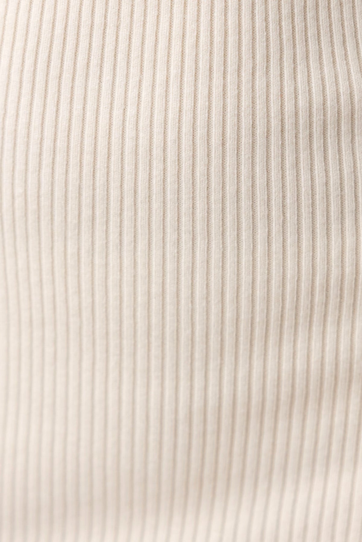Close-up of ribbed knit fabric in soft beige color, showcasing texture for Streep Midi Dress.