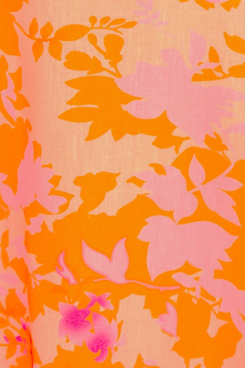Close-up of floral print fabric in vibrant orange and pink, featured in the Gratified Midi Dress.