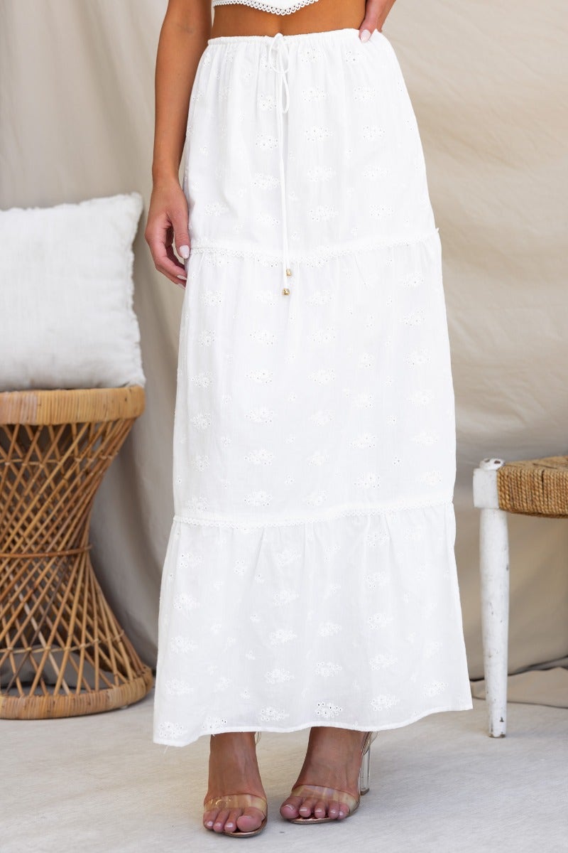 Long Live Maxi Skirt in Anglaise material, featuring an elastic waistband, lined design, and tiered hem in white.