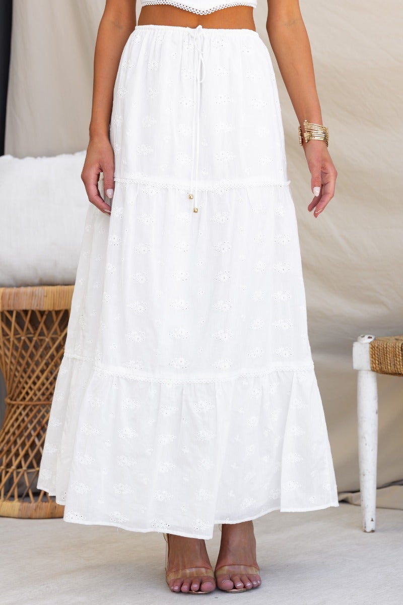 White Long Live Maxi Skirt with elastic waistband and drawstring, styled for a relaxed summer look.