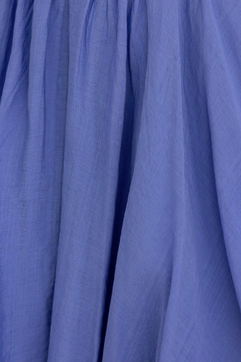 Close-up of soft, flowing violet fabric showcasing texture and drape for the Violet Chemistry Dress.