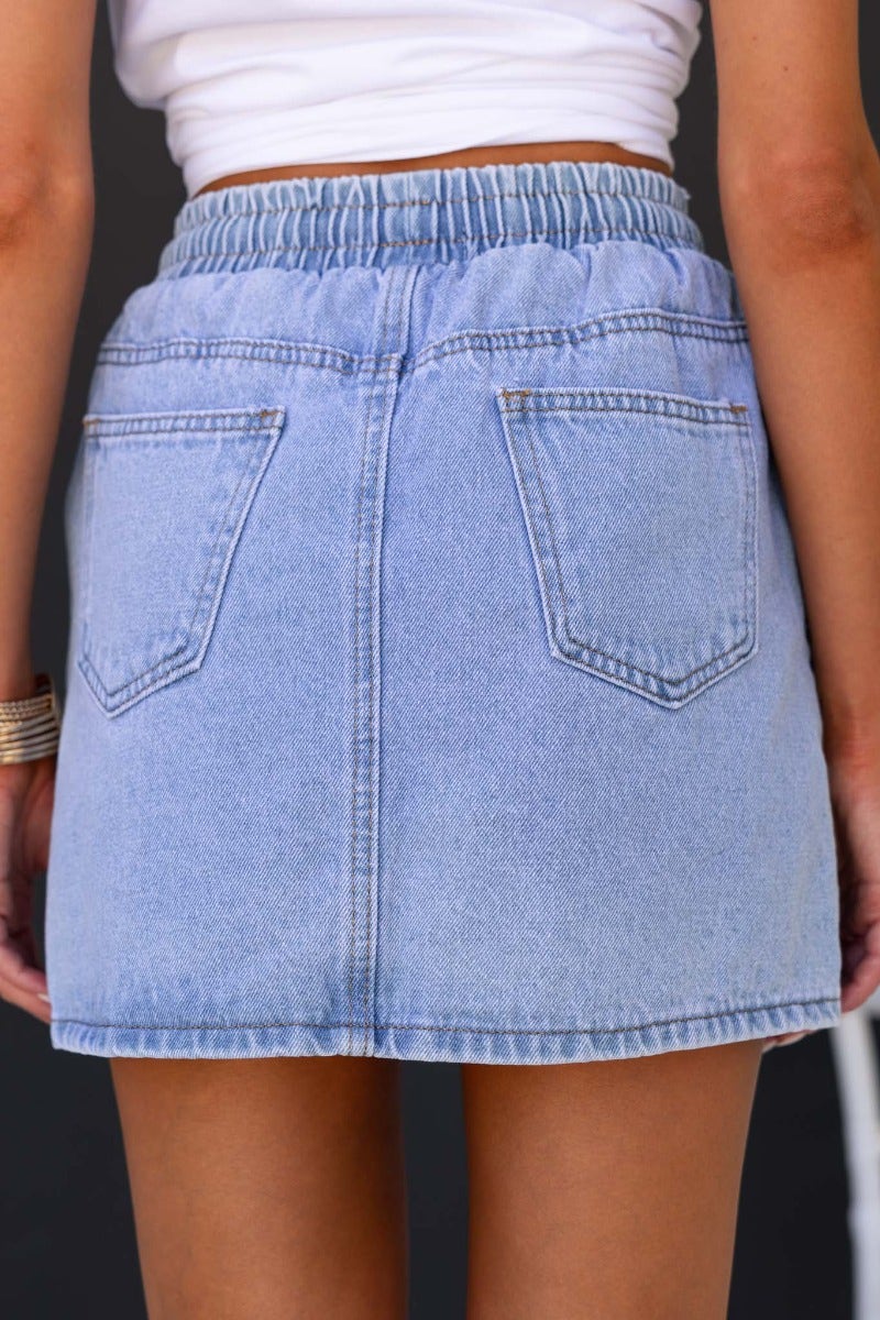 Back view of Serona denim skirt showcasing elastic waistband and pockets, highlighting light blue denim wash.