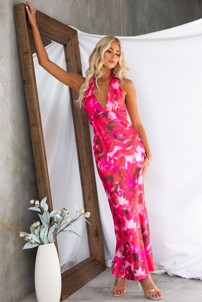 Model wearing Look Within Satin Maxi Dress in pink floral print, featuring a halter neckline and elegant long silhouette.