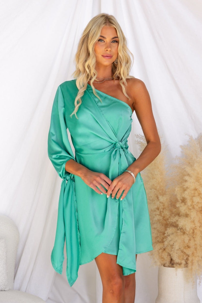 One-shoulder satin dress in teal with tie detail and wrap style, perfect for stylish occasions.