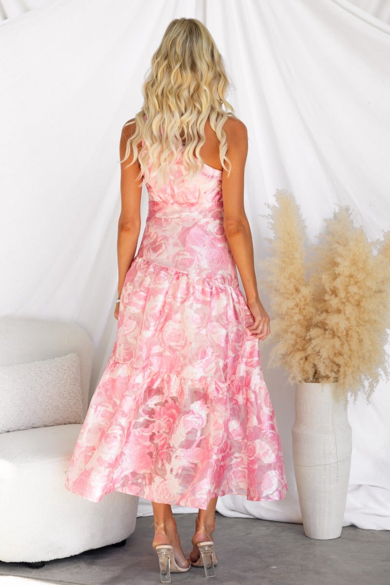Elegant floral print Royal Sun Maxi Dress showcasing a one-shoulder design and flowy silhouette from the back.