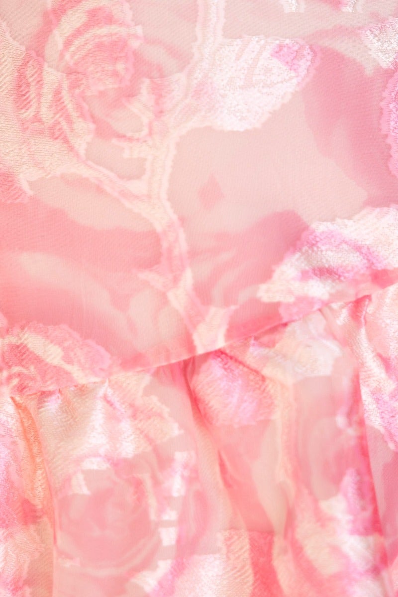 Close-up of floral print fabric in soft pink hues, showcasing the texture of the Royal Sun Maxi Dress.