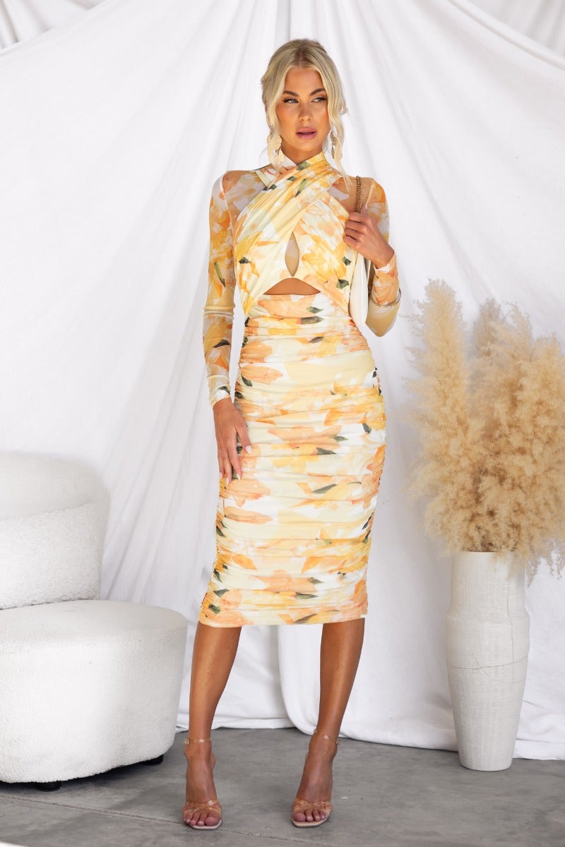 Thousand Miles Midi Dress featuring a bodycon style with cross-over bust and cut-out waist in a vibrant floral print.