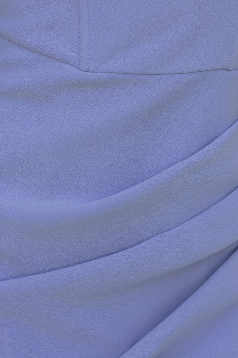 Close-up of the fabric texture of a lavender bodycon midi dress, showcasing draped details and smooth finish.