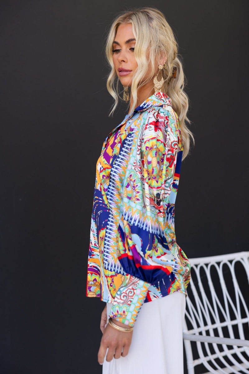 Model wearing the Indianna Shirt, a vibrant navy print button-up with a satin feel and relaxed fit.