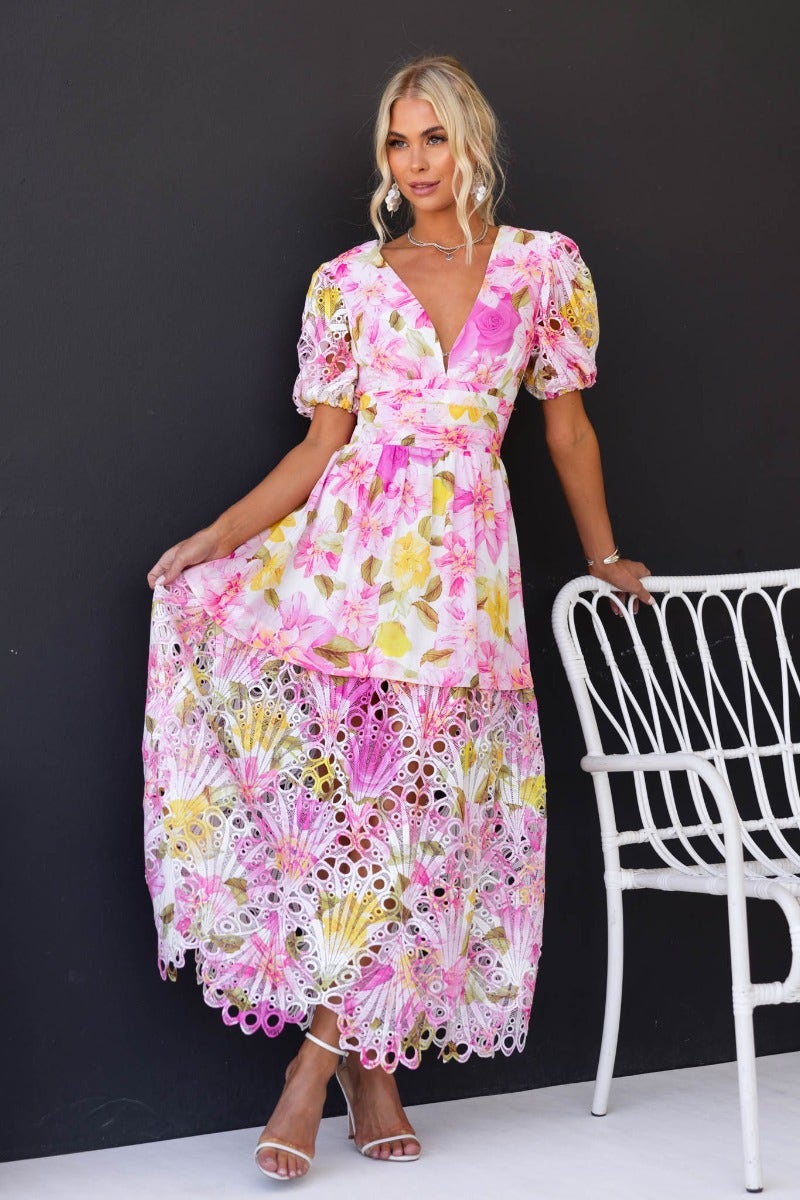 Forever Free Floral Maxi Dress with V-neckline and puff sleeves, styled elegantly with lace hem on a model.