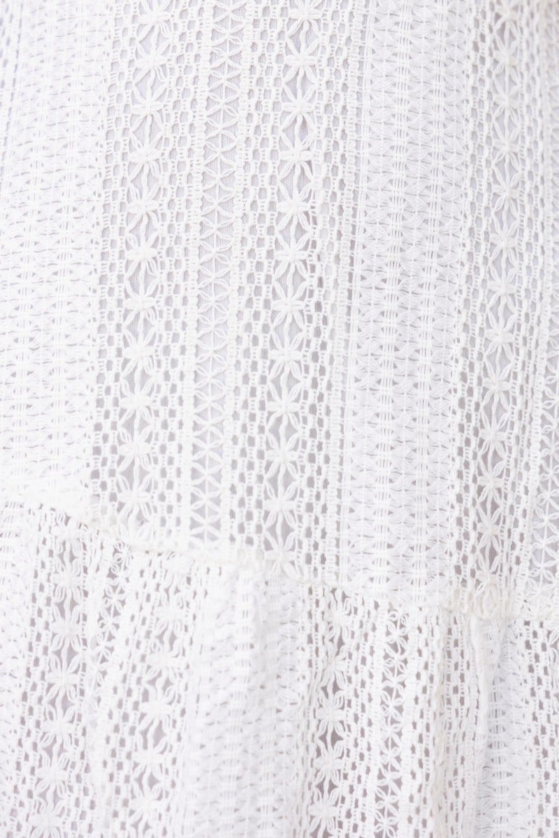 Close-up of the crochet detail on the Beautiful Liar Midi Dress, showcasing intricate patterns and textures.