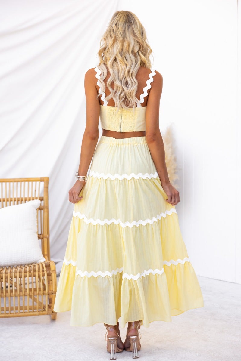 Back view of Breezy Morning Set featuring a yellow cotton maxi skirt and a matching top with scalloped edges.