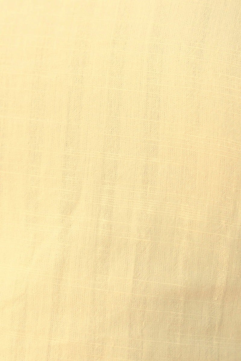 Close-up of soft, lightweight cotton fabric in a pale yellow shade, ideal for summer clothing.
