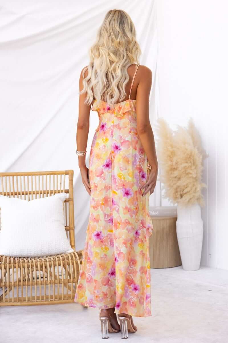 Back view of a floral print Aquarius maxi dress with adjustable straps and ruffle detailing.