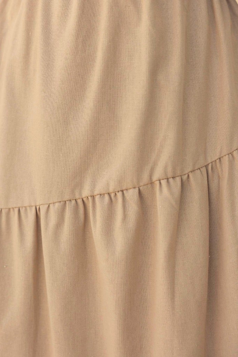 Close-up view of Oteo Midi Dress in beige linen blend fabric with gathered waist detail.