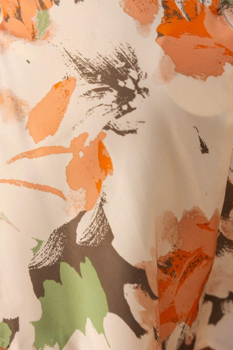 Close-up of floral pattern in soft fabric, featuring shades of orange, green, and brown for the Full Circle Dress.