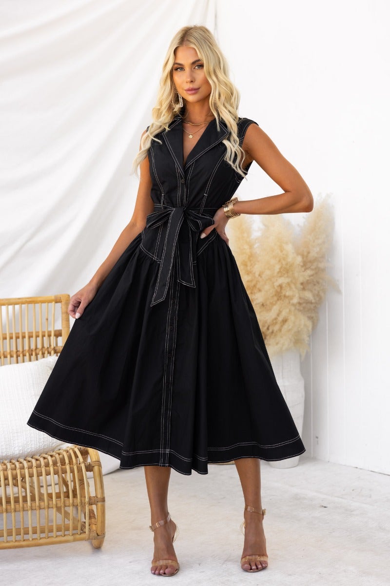 Black midi dress with collar and button-up front, featuring a removable tie and slightly relaxed fit.