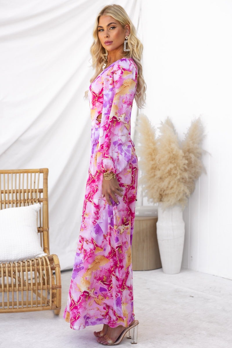 Model wearing a vibrant pink and purple satin Orlando maxi dress with a round neckline and open back tie detail.