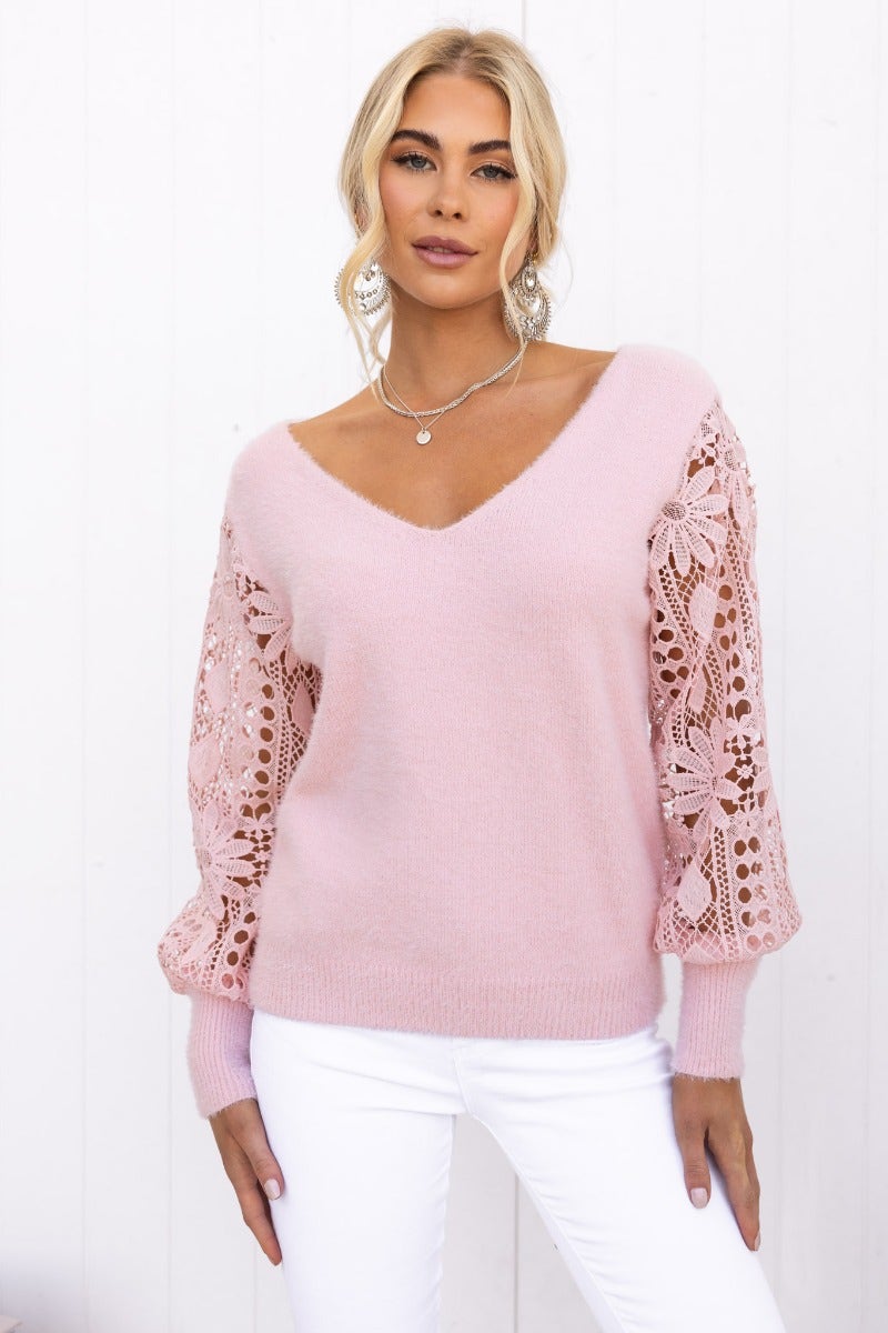 Fluffy pink V-neck jumper with lace sleeves, perfect for stylish casual wear, featuring a relaxed fit and cozy knit material.