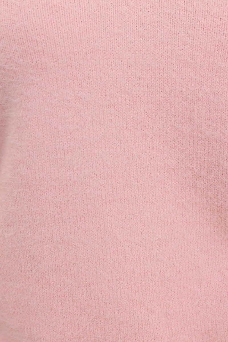 Close-up of a fluffy pink knit fabric showcasing its soft texture, perfect for an Indya jumper.
