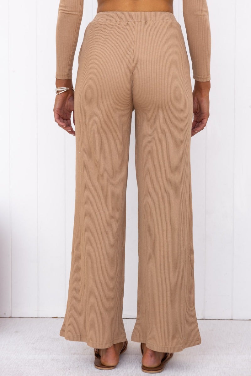 Back view of Smitten Pants showcasing elastic waistband and wide legs in a ribbed beige knit.