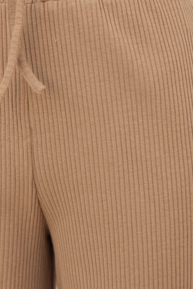 Close-up of Smitten Pants showcasing the ribbed fabric and elastic waistband in a tan color.