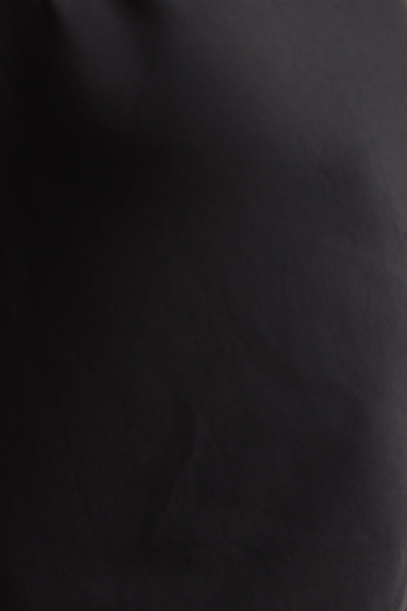 Black satin fabric texture showing the sleek look of the Ellisia Maxi Dress with one-shoulder design.