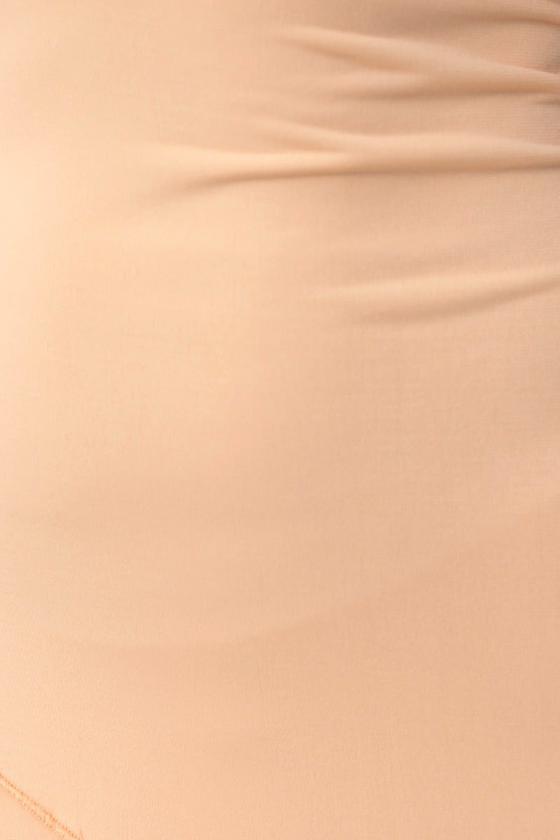 Close-up of the fabric of the Kaitey Maxi Dress showing stretchy material in a nude color.